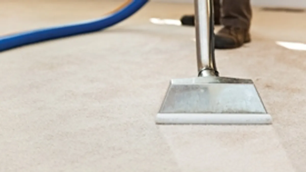 Carpet cleaning wand head gliding over a light carpet during hot-water extraction, Overland Park, KS.